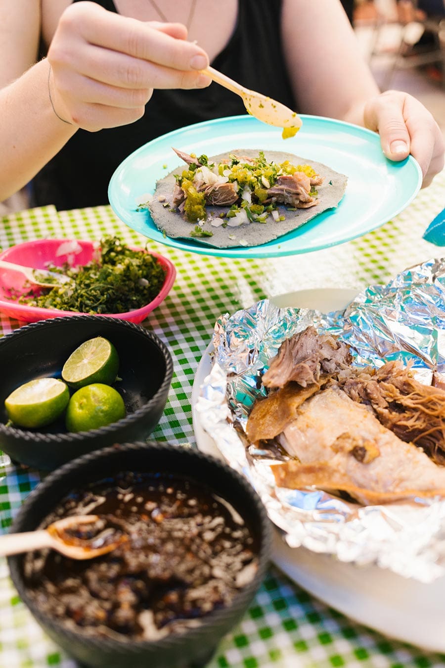 People sharing tacos and beans at Barbacoa Los Tres Reyes in Mexico City