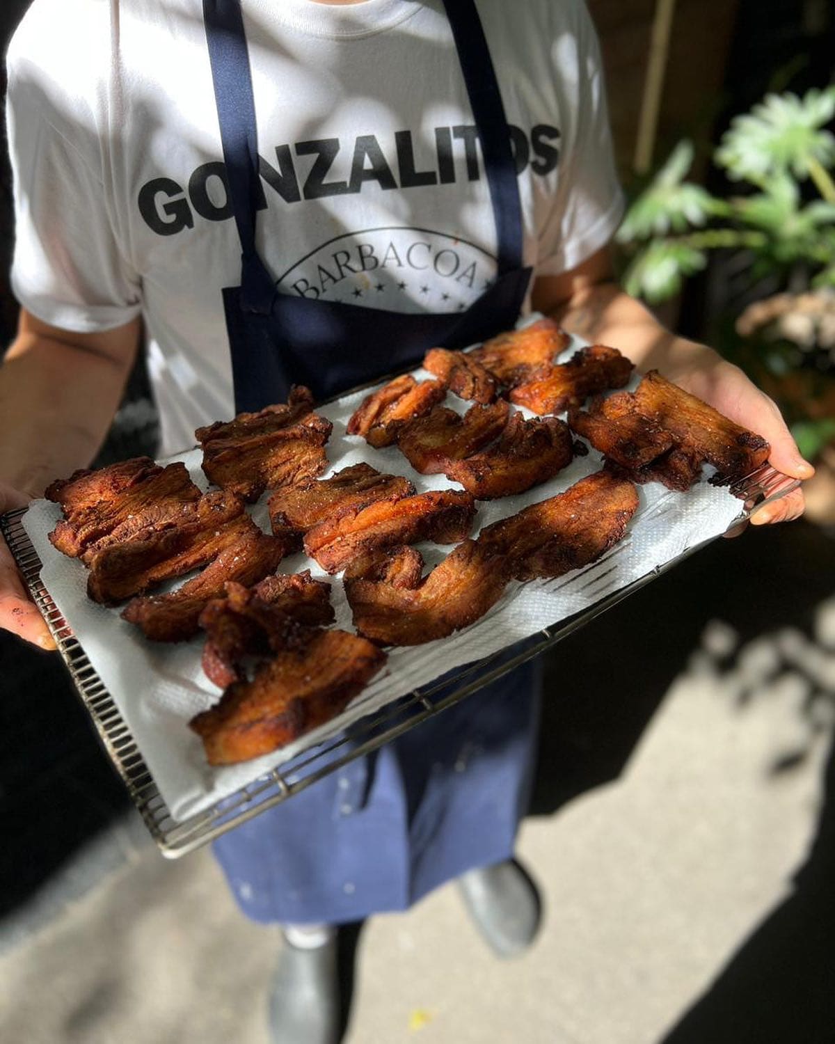 A staff member displaying a plate of freshly prepared food