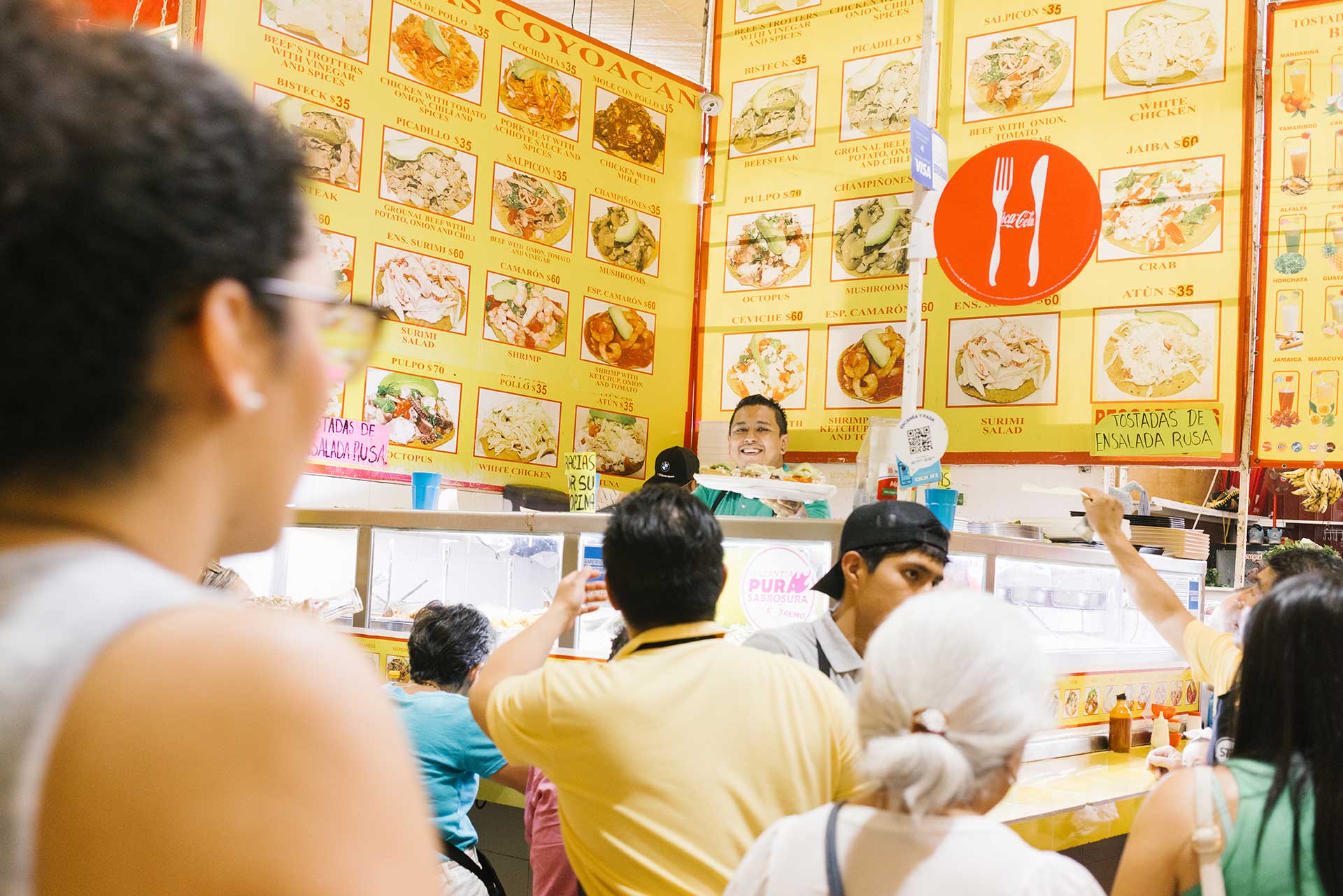 People queue in front of the menu at Tostadas Coyoacan Las Originales, Mexico City