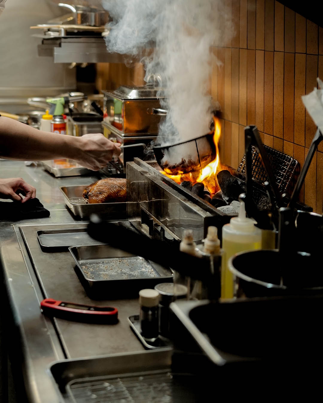 A chef cooking in the kitchen at Willow, Singapore.