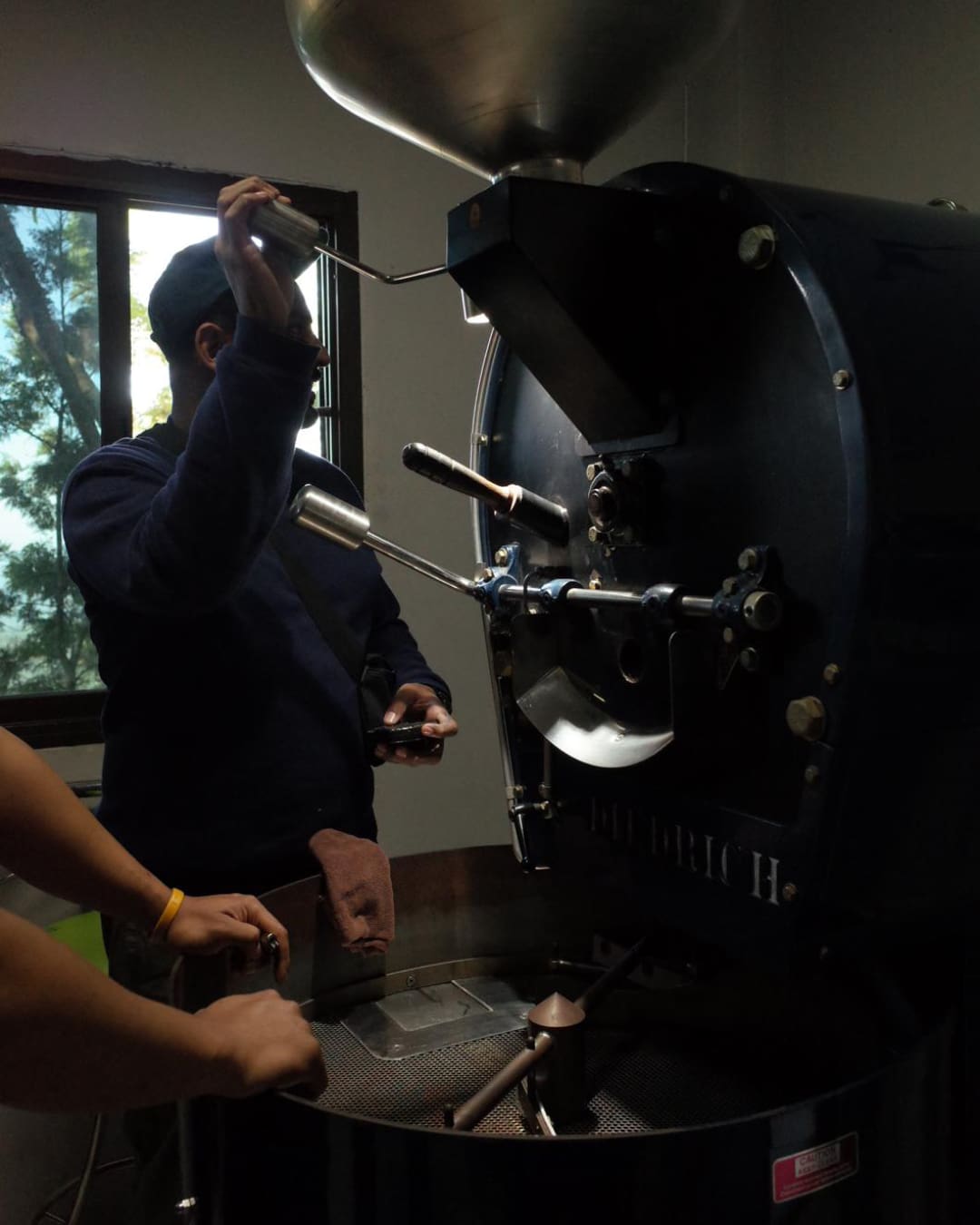 Karo Lyash, the owner of Karo coffee shop roasting coffee beans