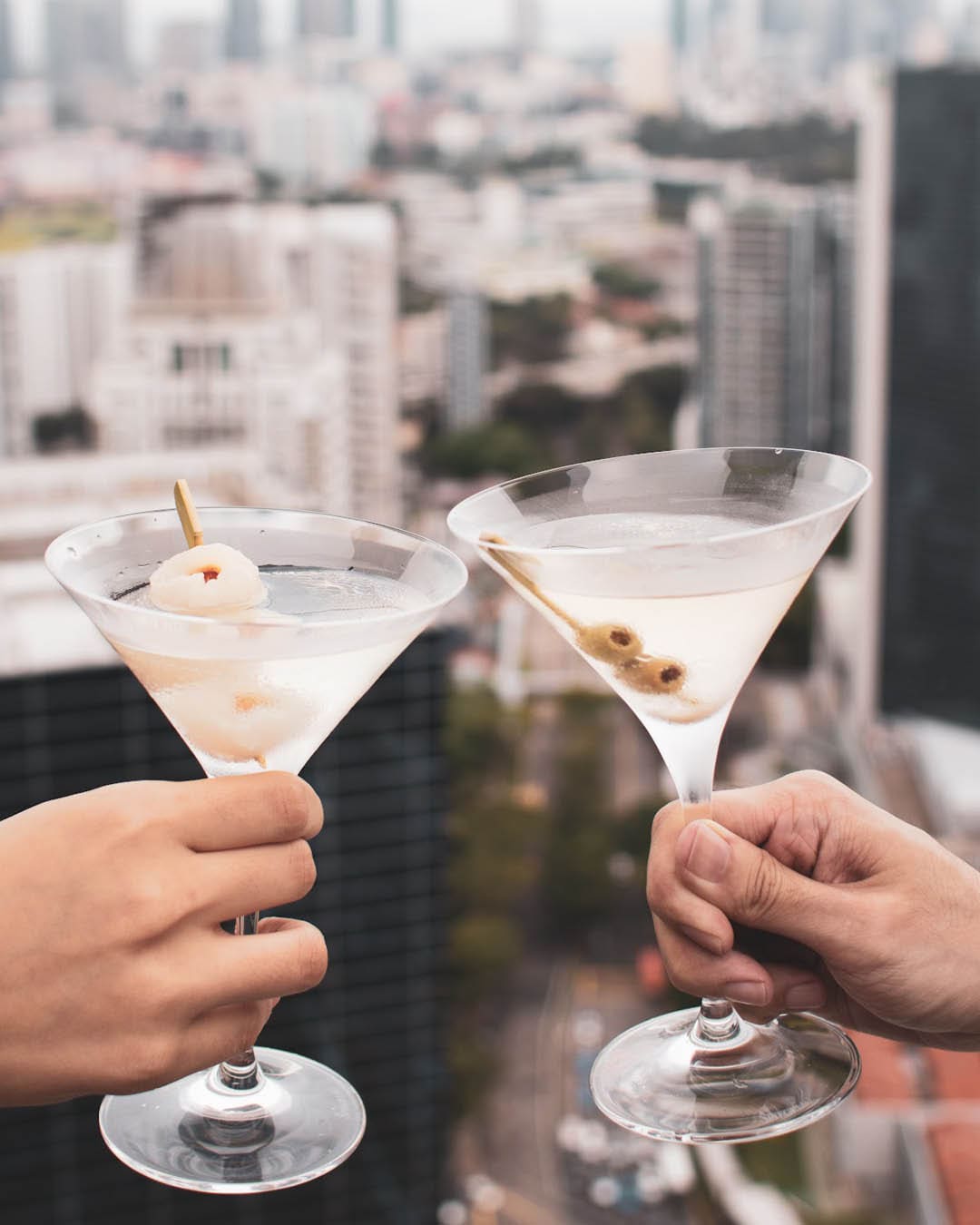 Martinis chinking at Las Palmas rooftop bar, Singapore.