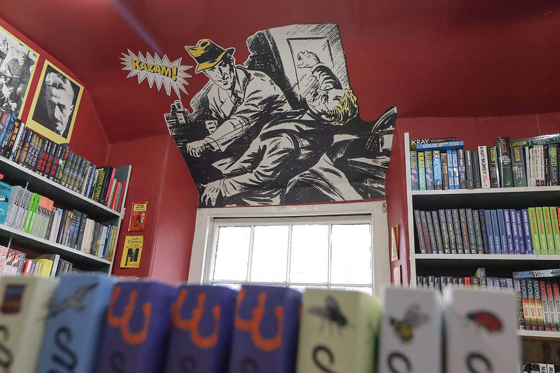 Comic mural and bookshelves at the Murder and Mayhem bookshop in Hay-on-Wye