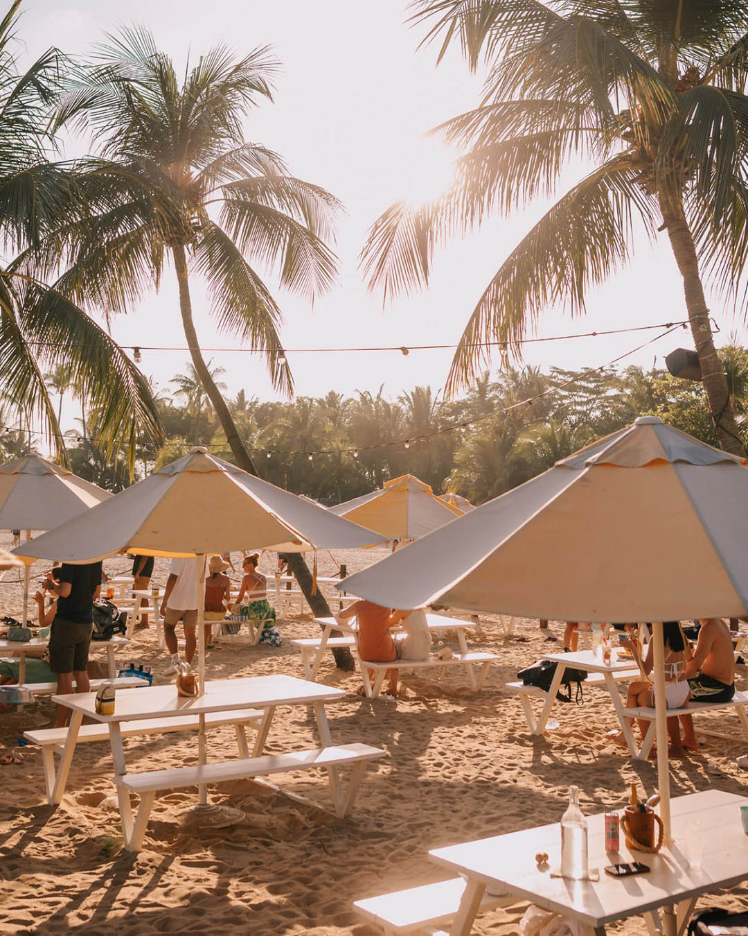 Tables and parasols at Tanjong Beach Club.