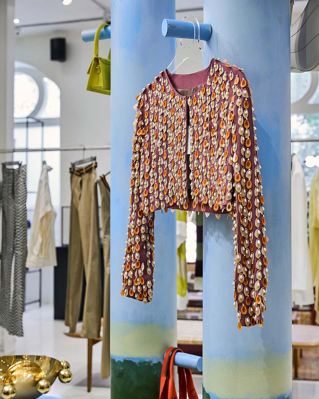 A sequinned jacket hangs on a blue pillar inside Le Mill boutique in Mumbai.