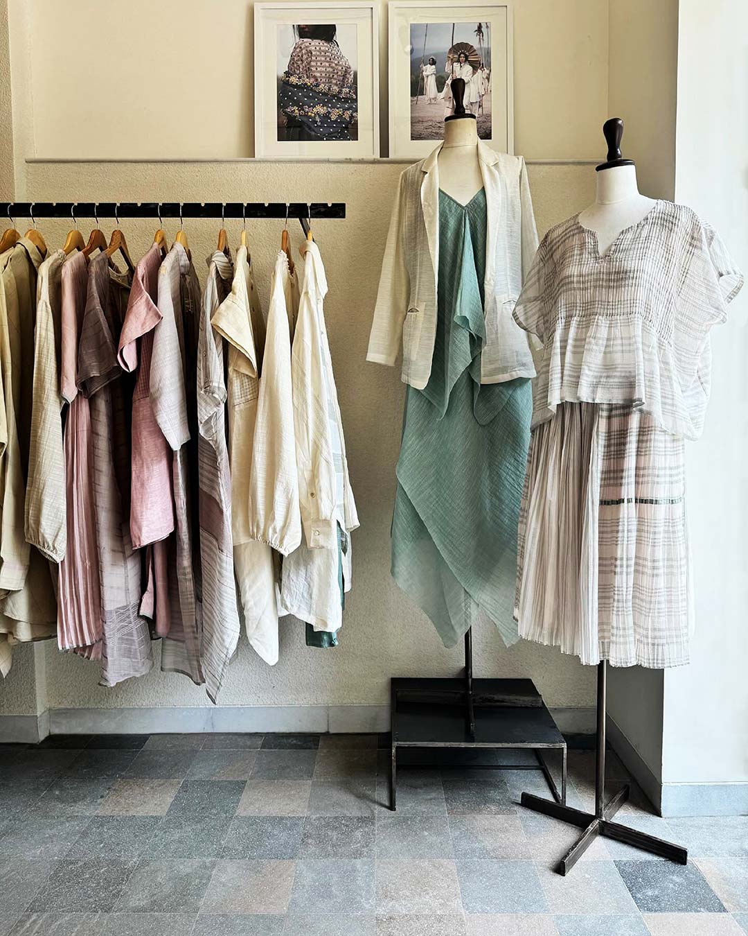 Clothing on display on a rack and on two mannequins at Ogaan boutique in Mumbai.