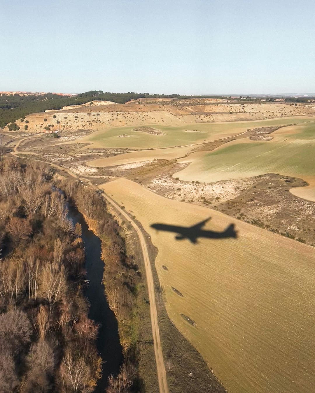 Aeroplane flies over fields