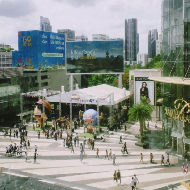 pedestrian shoppers outside siam paragon shopping mall in Bangkok