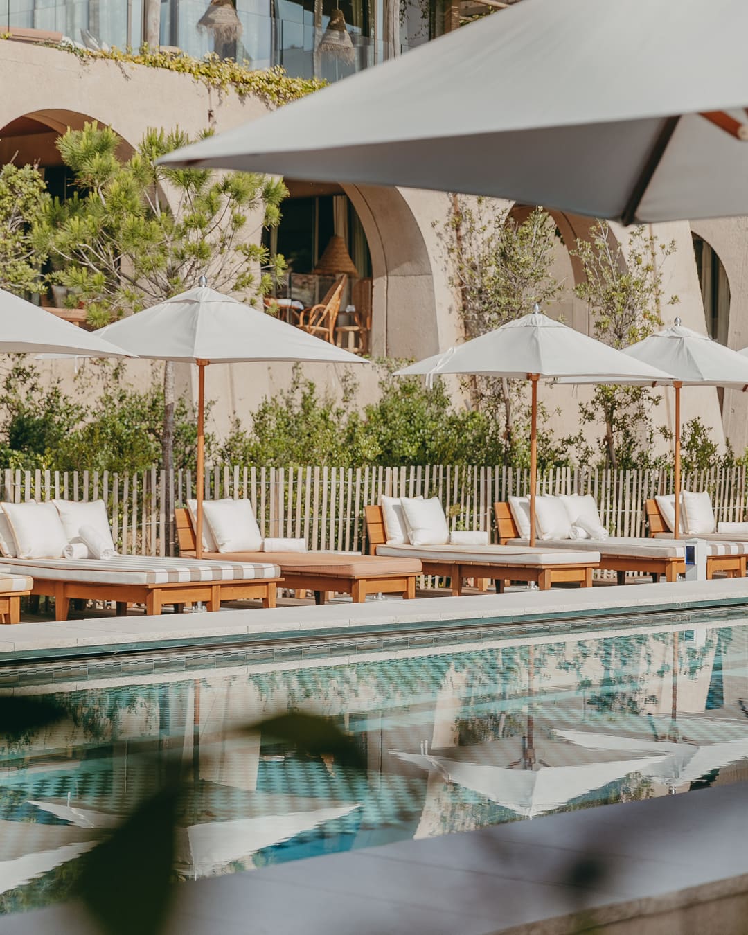 Sunloungers and parasols frame the pool at Lily of the Valley in Provence, France