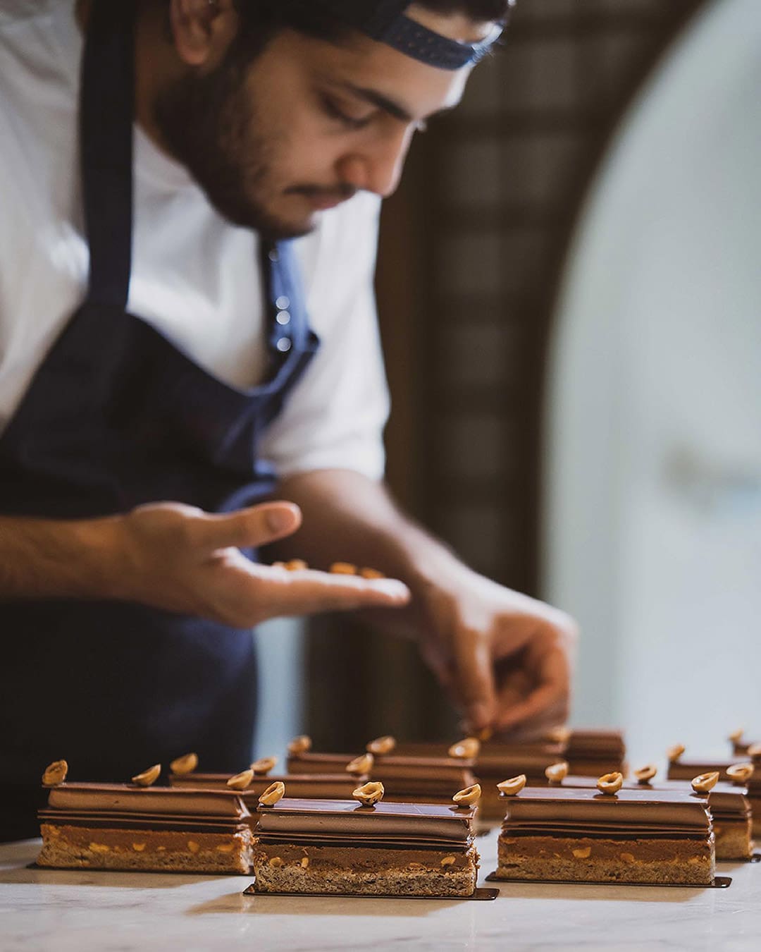 Omar Orfali, Head Of Pastry at Orfali Bros Bistro applies finishing touches to a dish