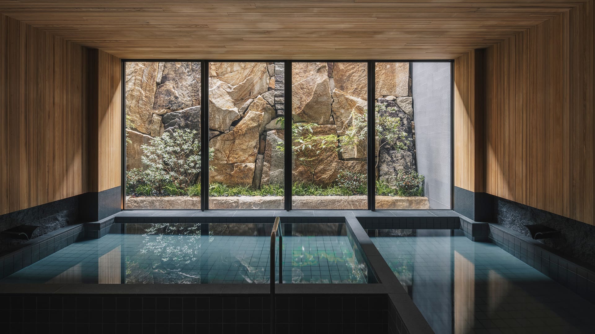 Indoor swimming pool looking out onto a garden at Six Senses Kyoto