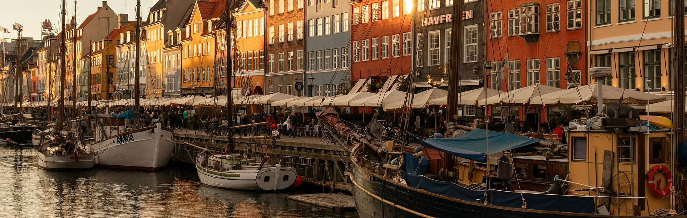 people enjoying sunset entertainment along the river in Copenhagen