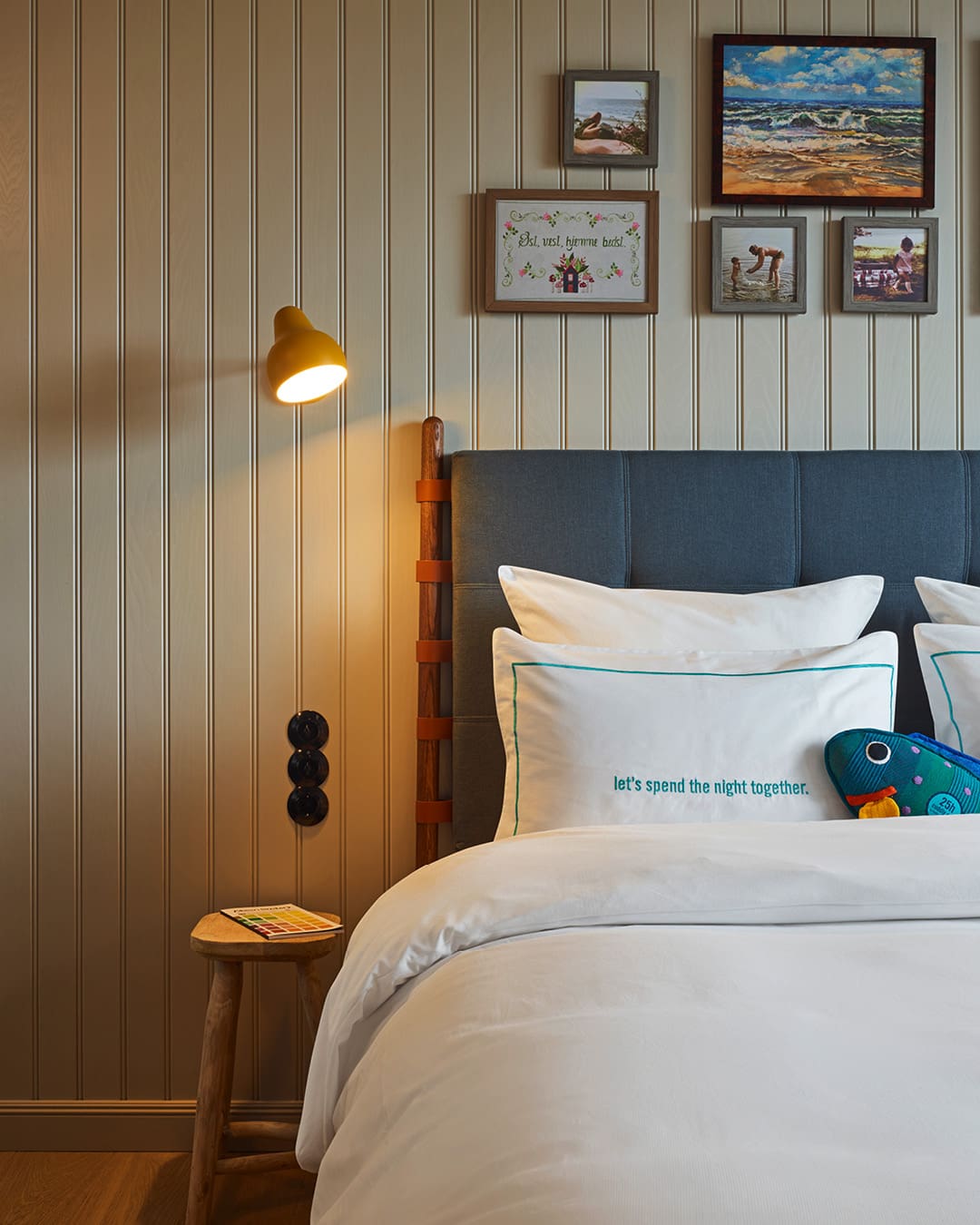 Wall art and painted timber walls decorate cabin-style rooms at 25Hours Paper Island Hotel