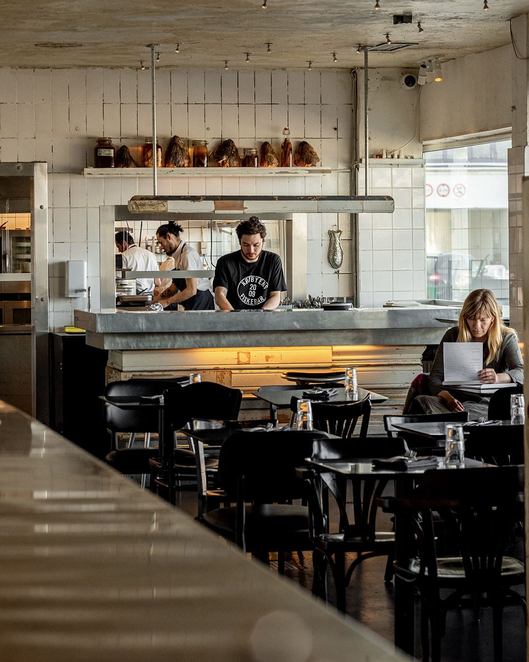 Warm welcoming resturant space of Kødbyens Fiskebar. WIth customers and staff