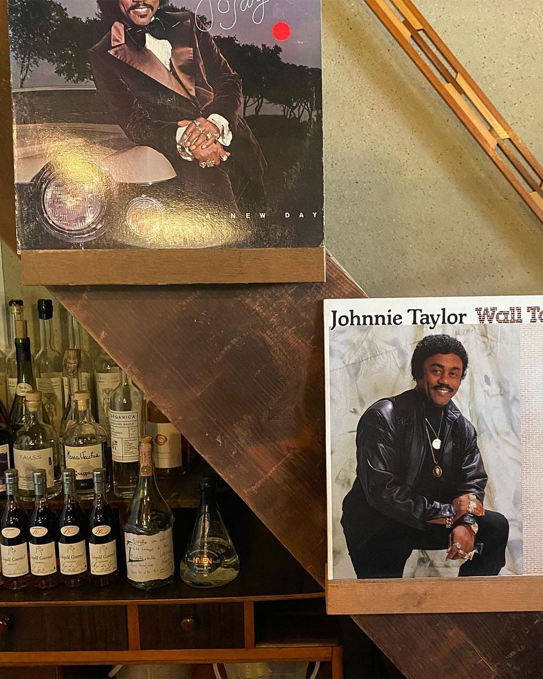 Bottles of wine and vinyl record sleeves on display at Dupree natural wine bar in Kyoto.