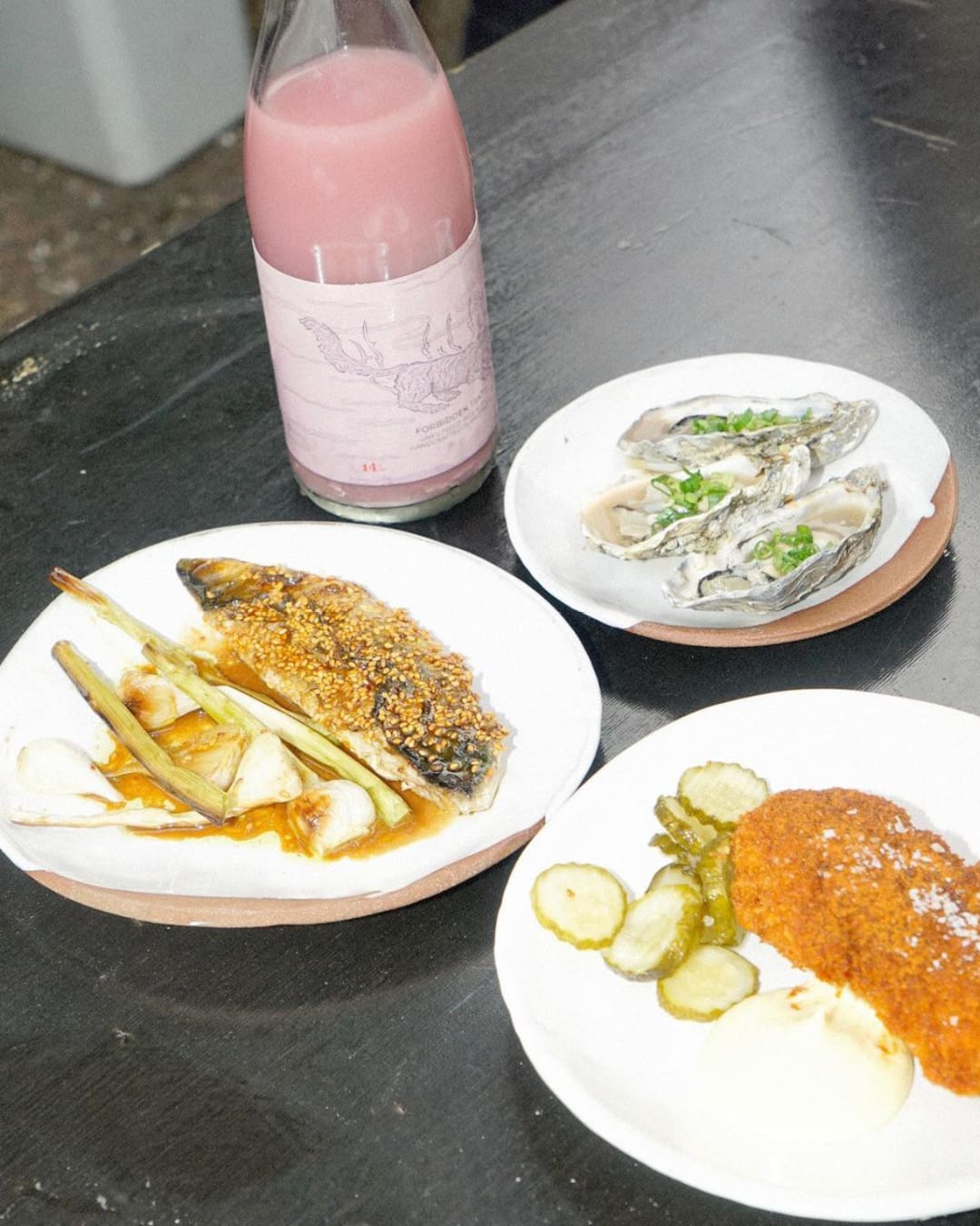 Grilled oysters, grilled mackerel with kimchi sesame seeds alongside fried chicken at Villette.