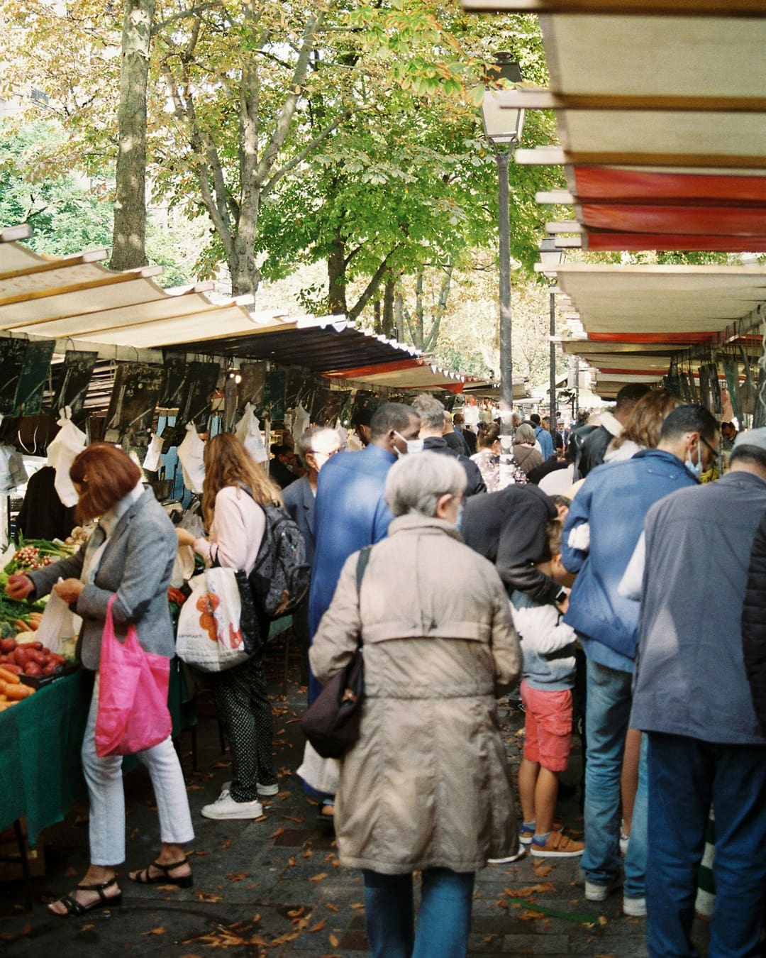 people at a food market in belleville paris france