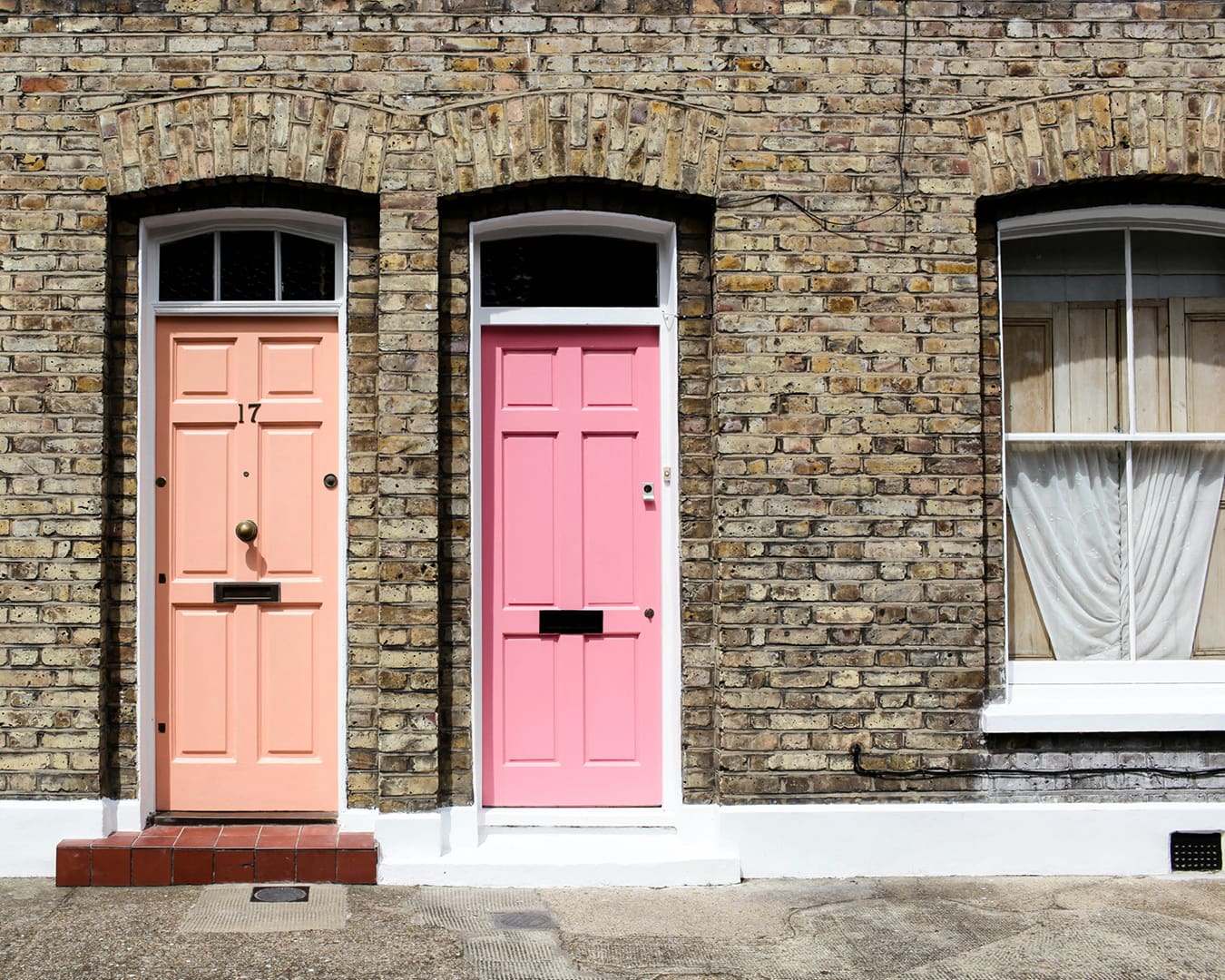 Neighbouring pink front doors on Columbia Market, London