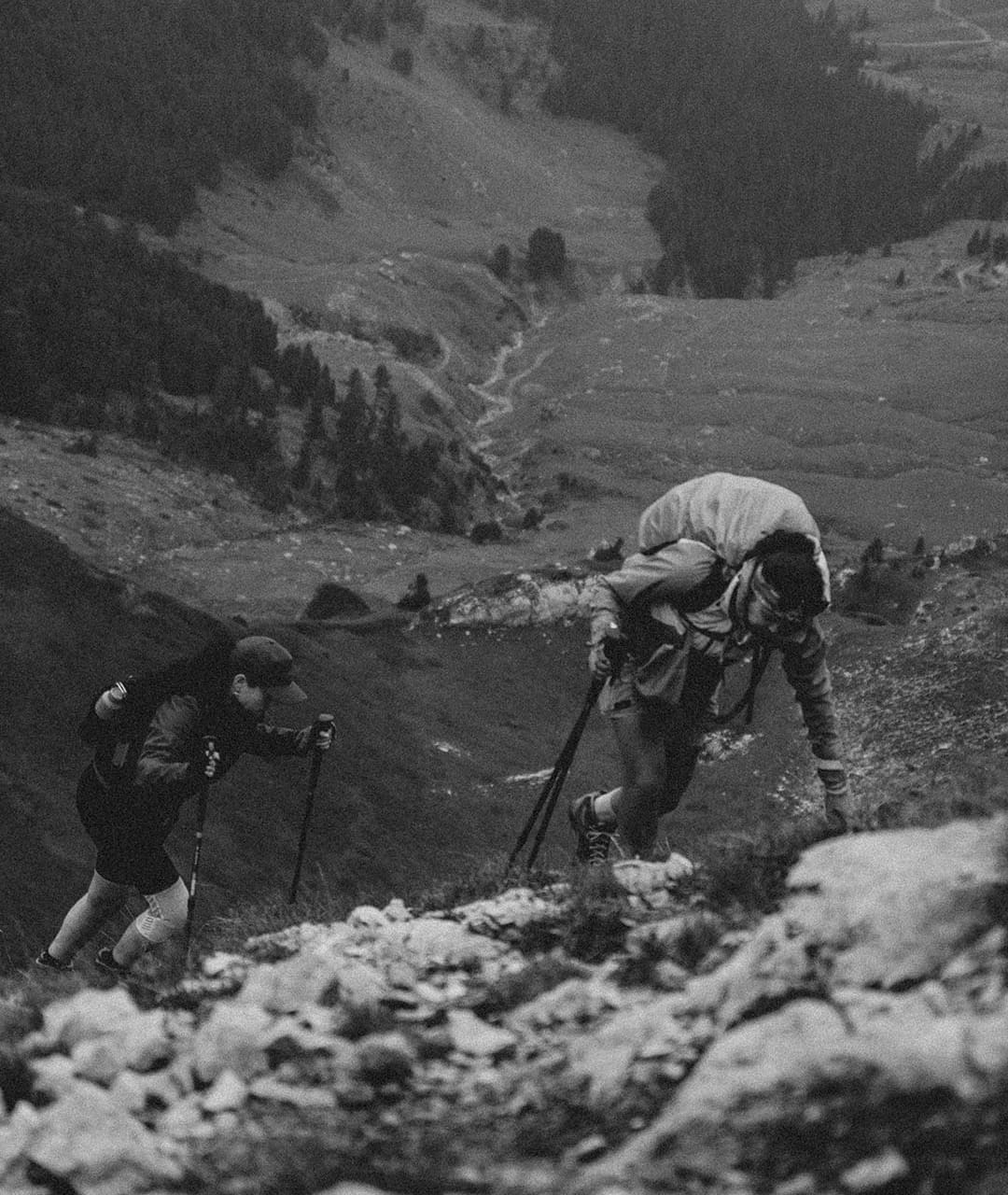 A black and white photo of two hikers scaling the Albanian Alps