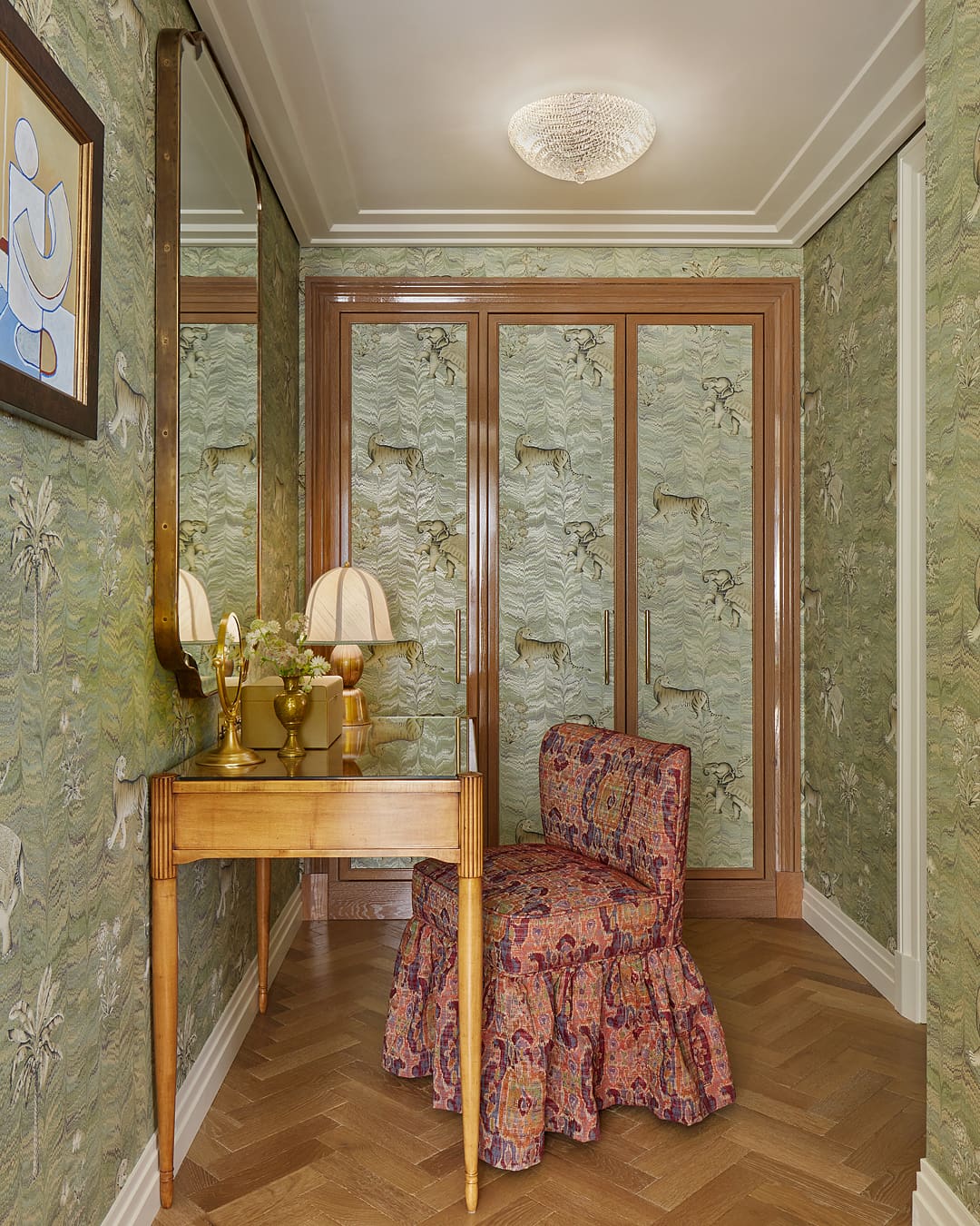 An upholstered chair and wallpapered wardrobes define a vanity are at Broadwick Soho