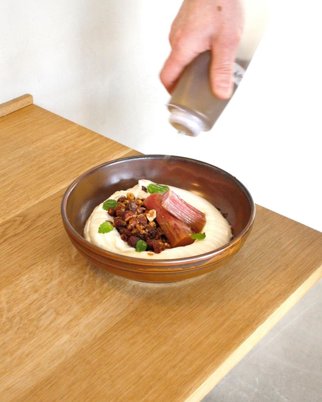 Seasonal rhubard granola being plated at Wild Horses coffee shop in Copenhagen.