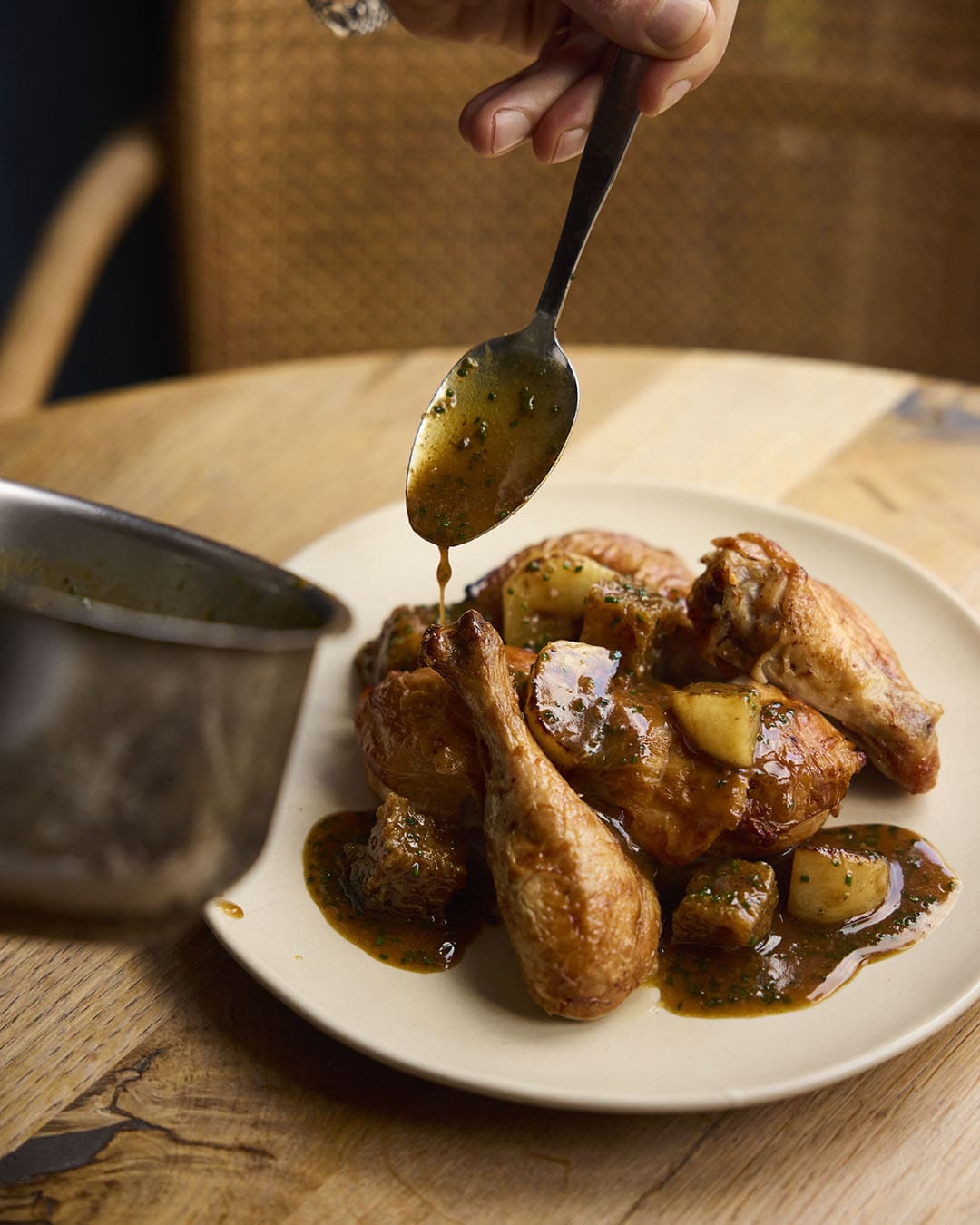 A waiter serves roast chicken with Café De Paris butter at Dove.