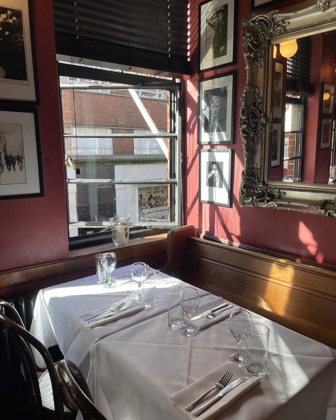 An atmospheric white table cloth setting at The French House in Soho