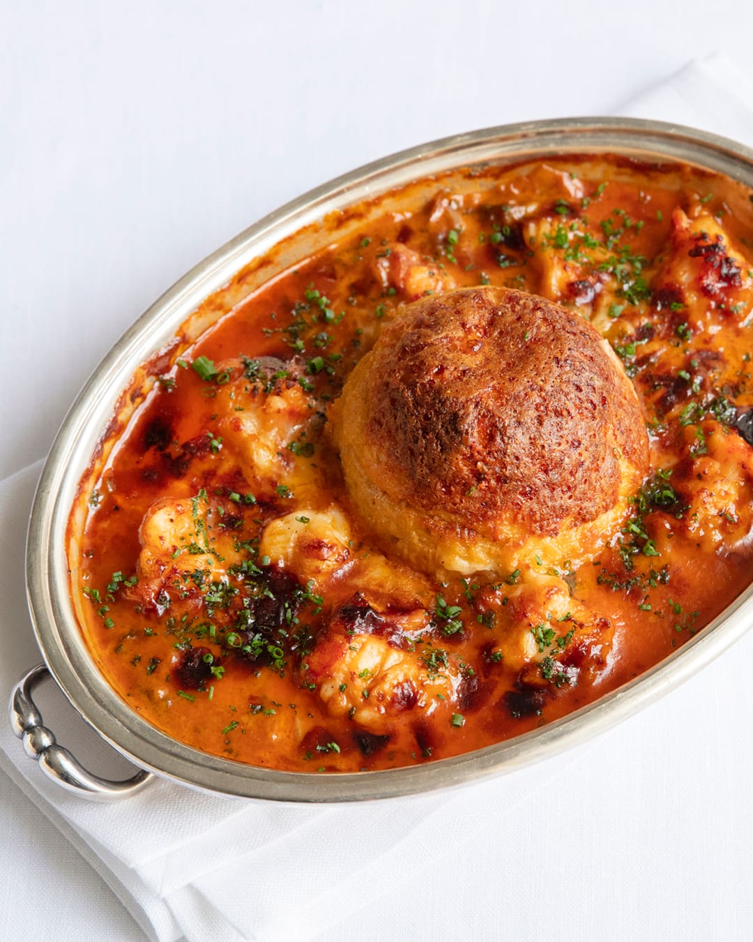 A creamy, tomato dish served on Julie's white table cloths