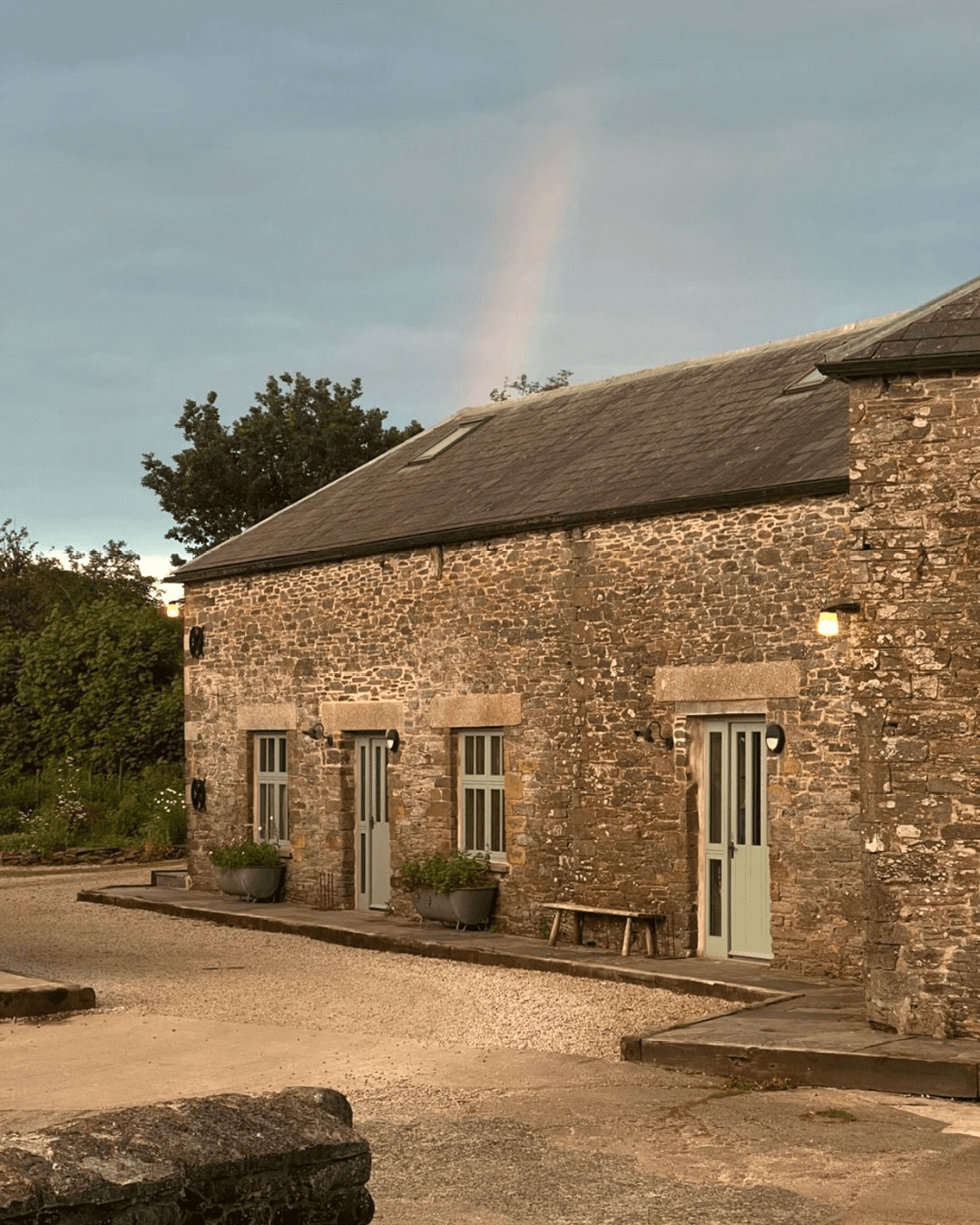 Rainbow over Coombeshead Farm at sunset