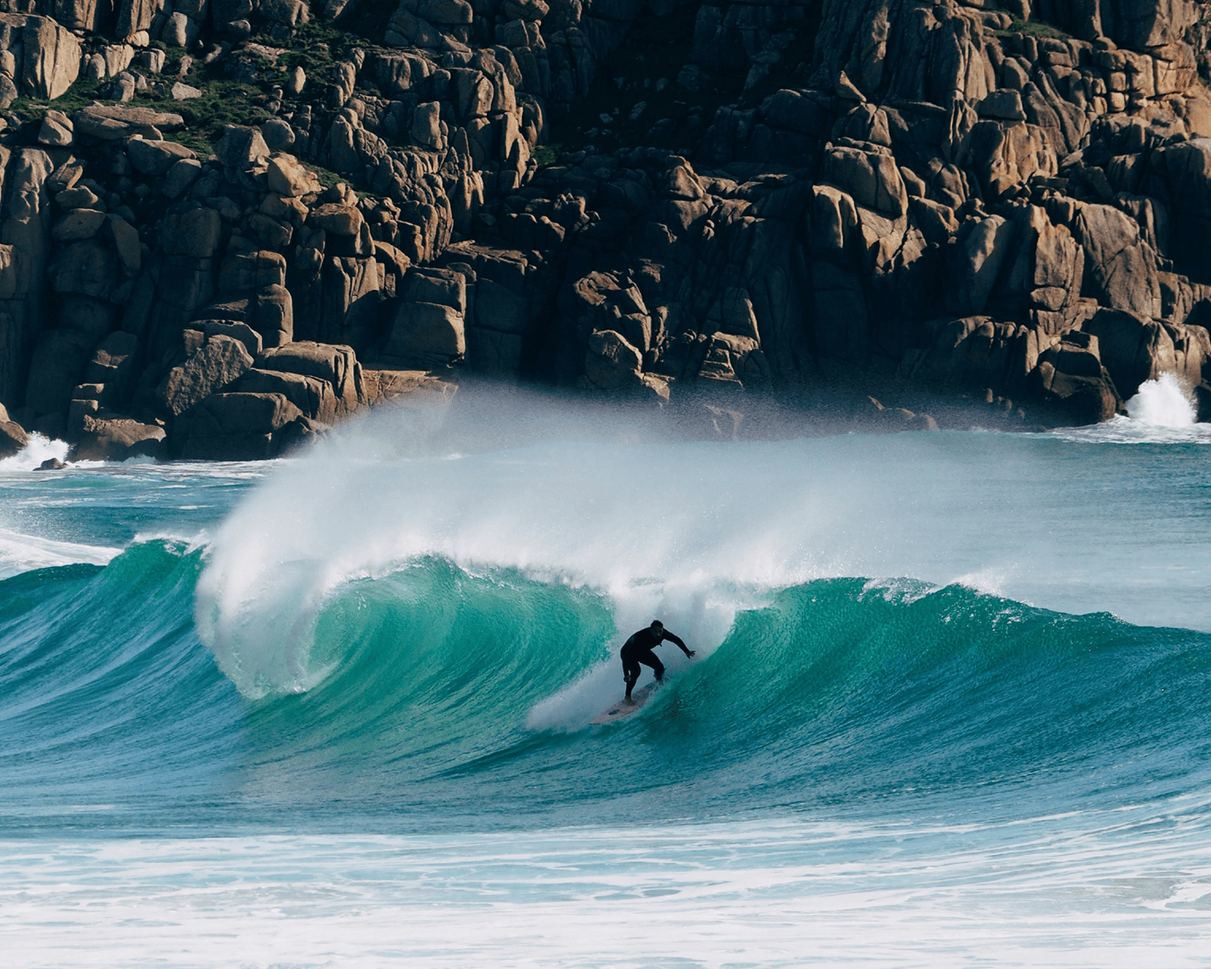 A surfer catches a clean wave