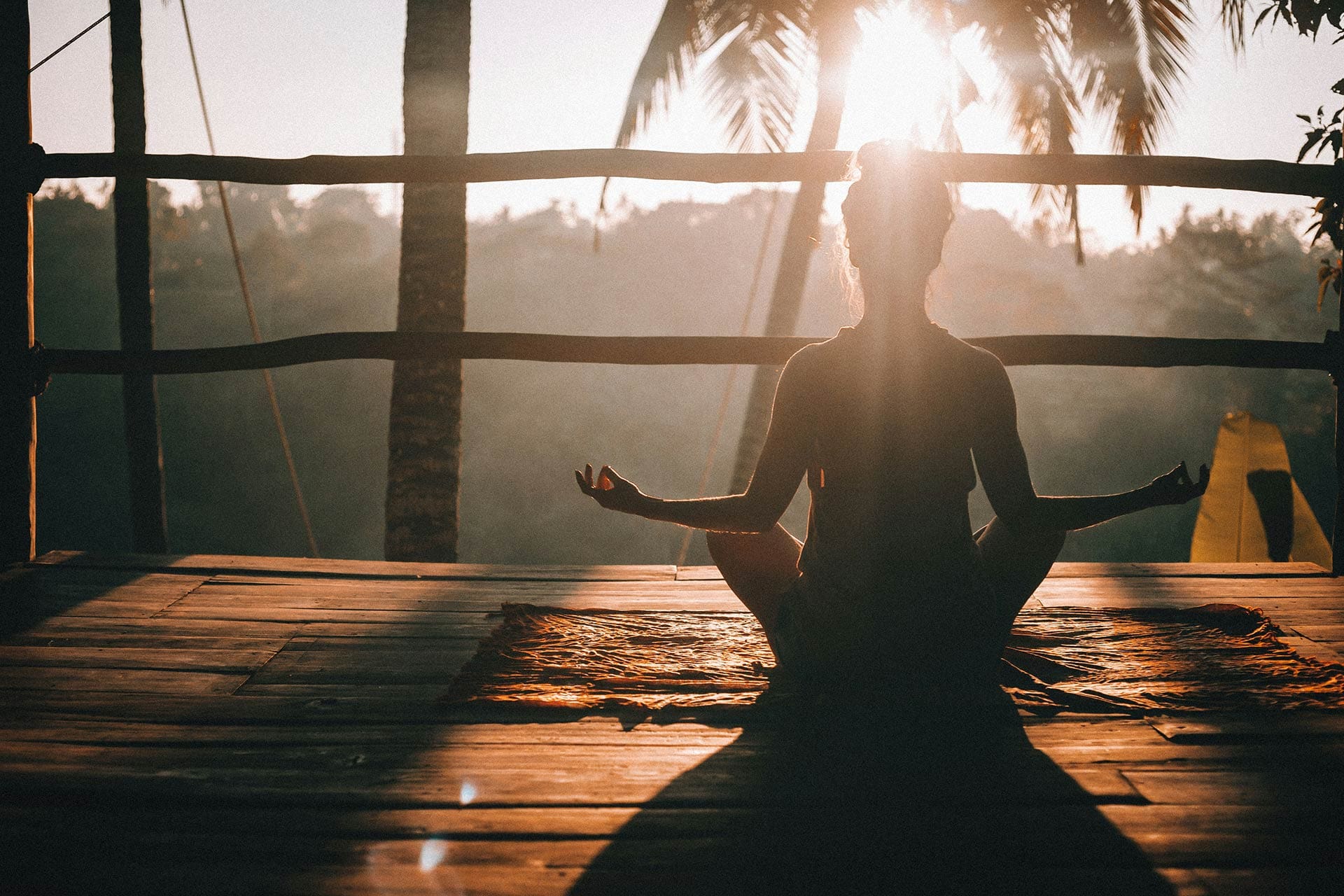 Yoga pose above the jungle canopy in Bali