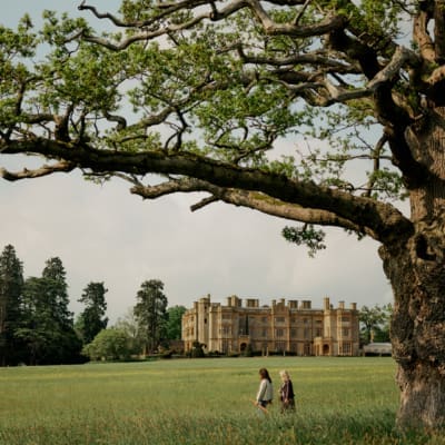 Two people walking in the expansive grounds at Estelle Manor