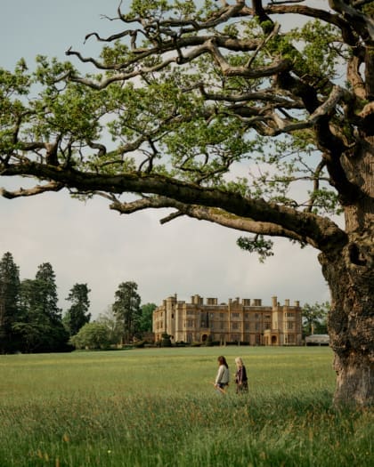 Two people walking in the expansive grounds at Estelle Manor