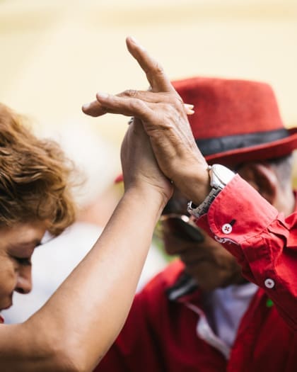 A couple hold hands while dancing in Mexico City