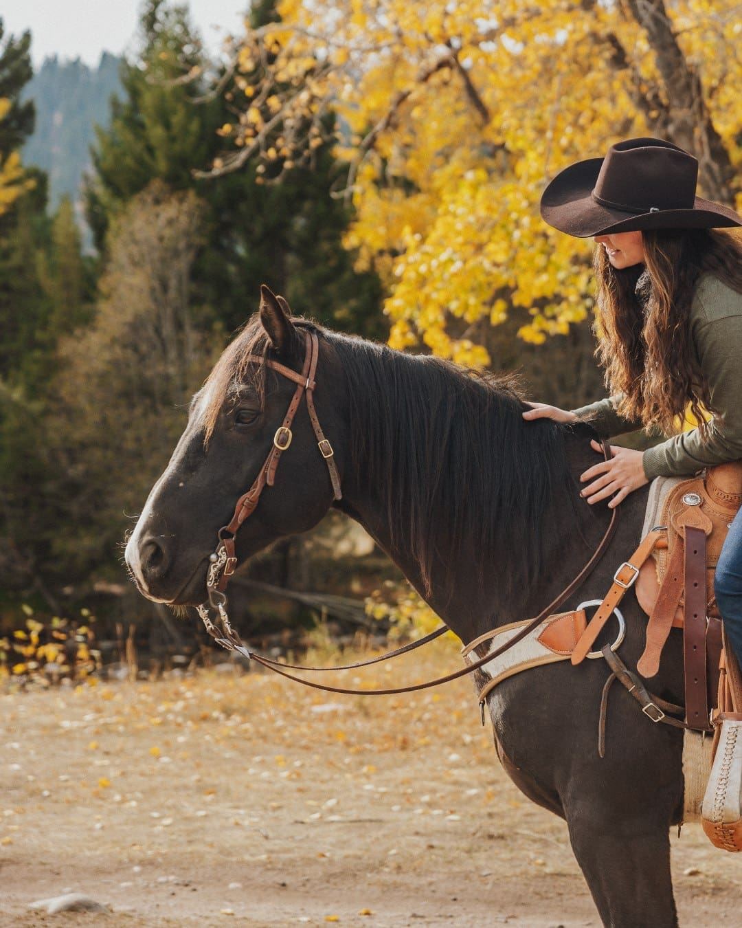 A women on a horse at The Ranch at Rock Creek in Montana