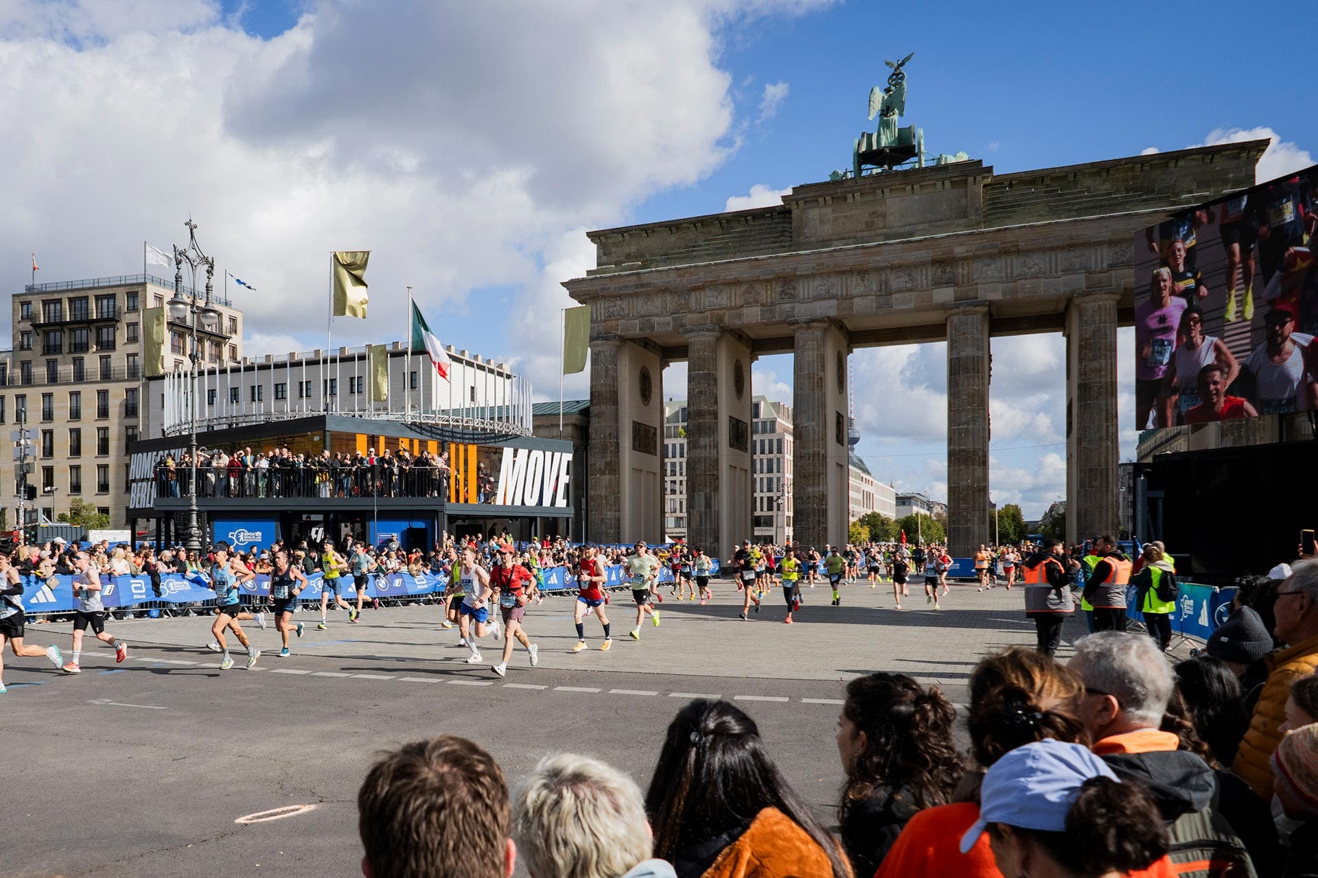 Finishers crossing Brandenburg Gate at the end of Berlin Marathon. 