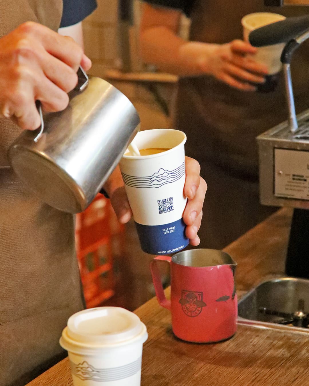 Pouring a latte at Brother Baba Budan in Melbourne.