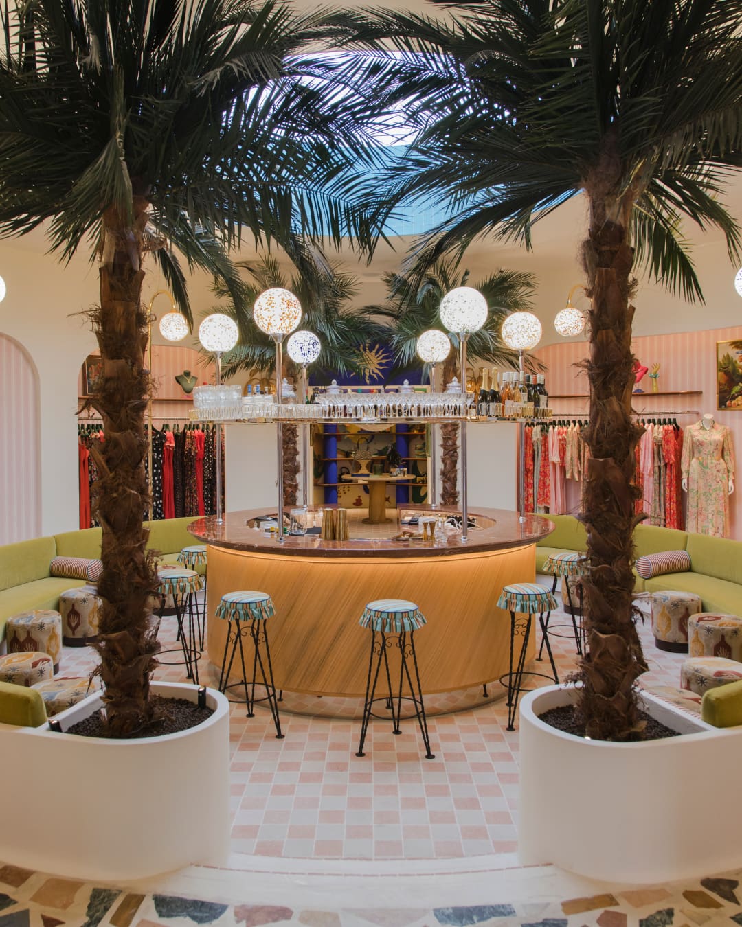 Potted palm trees flank a cocktail bar at Rixo on King's Road in Chelsea