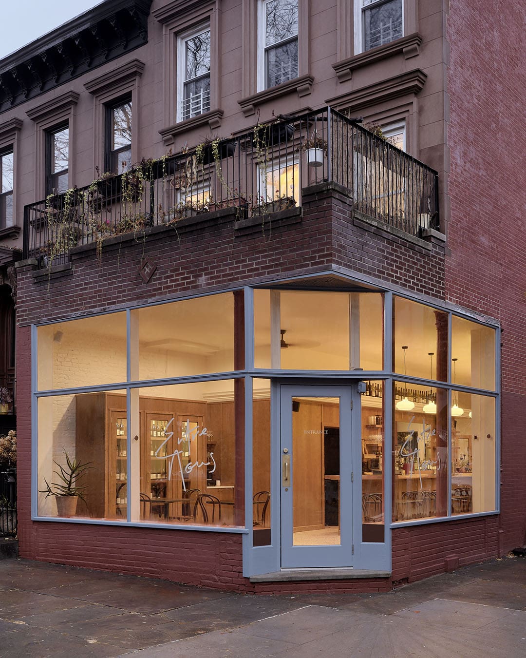 Exterior of Entre Nous, a wine bar in New York City. Warm, inviting, NYC