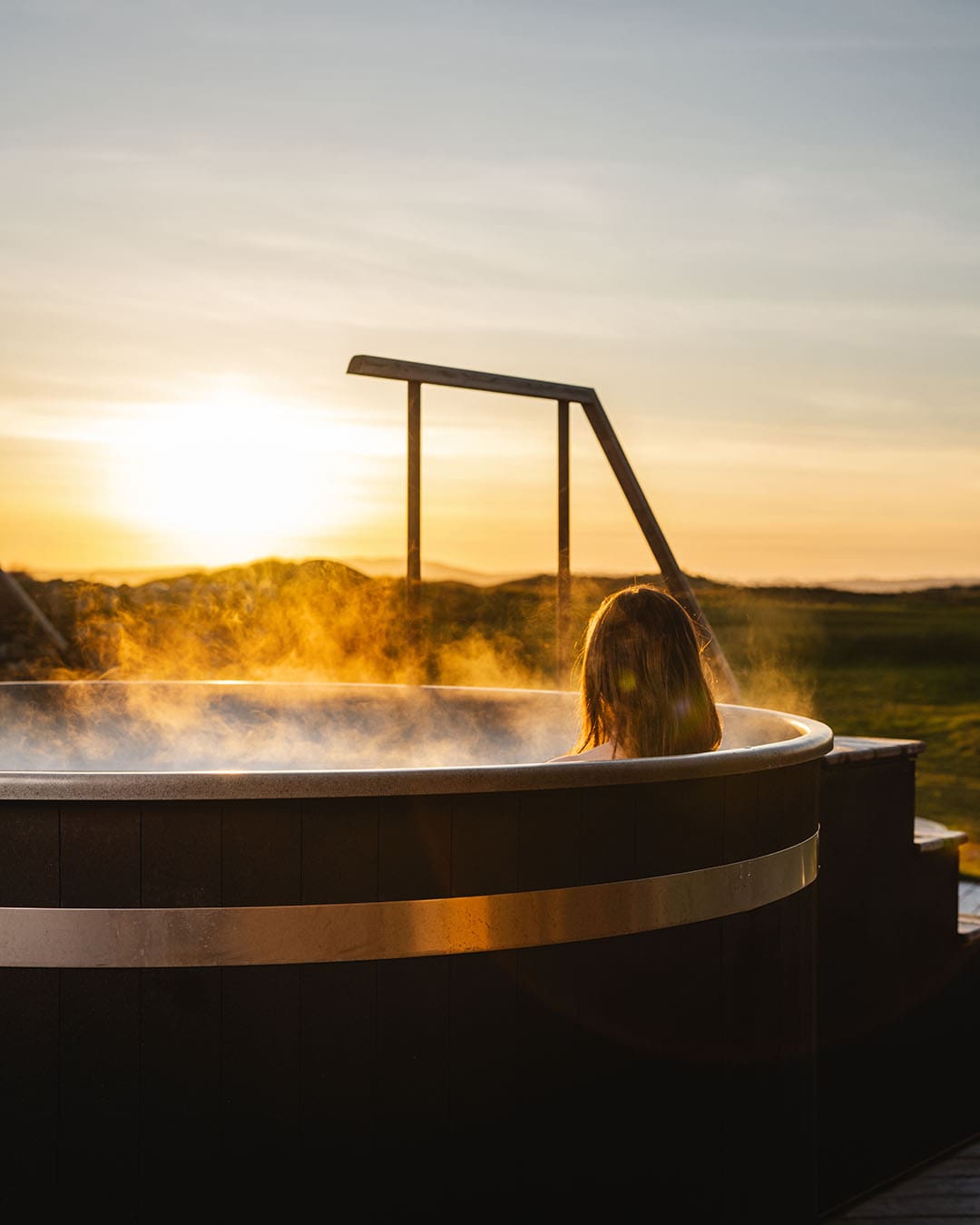 A woman relaxes in the hot tub at The Machrie