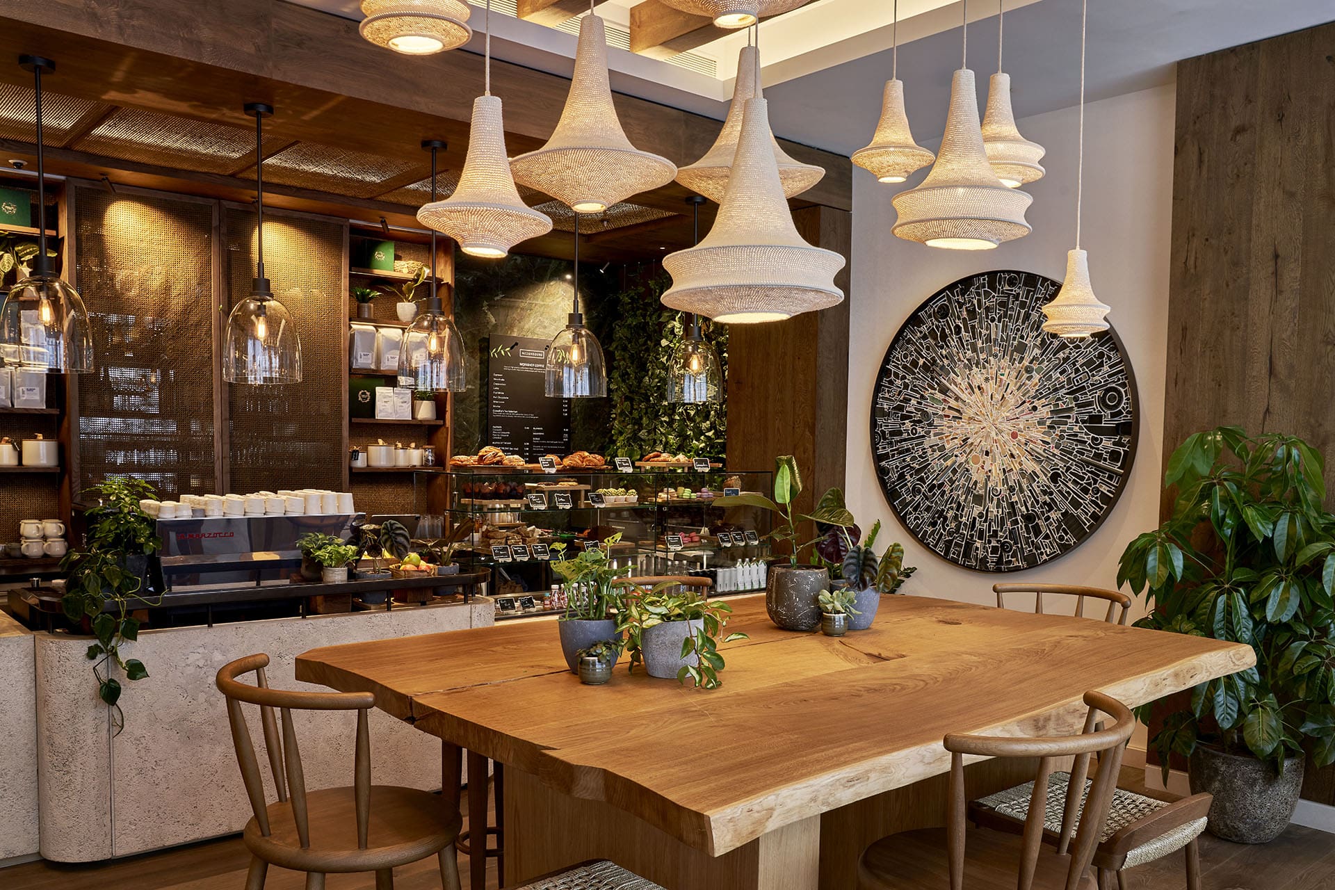 Neighbours cafe at 1 Hotel Mayfair, where guests can sip coffee around a communal table