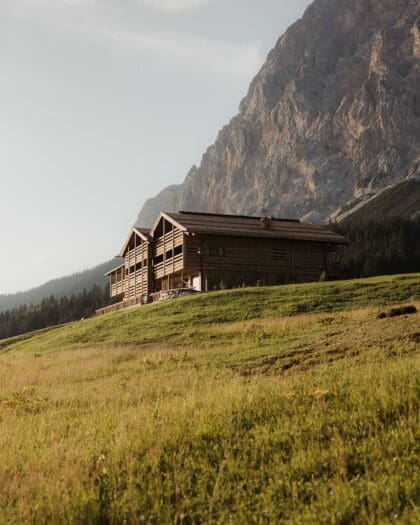 A wooden hotel set in fields and mountains of Austria