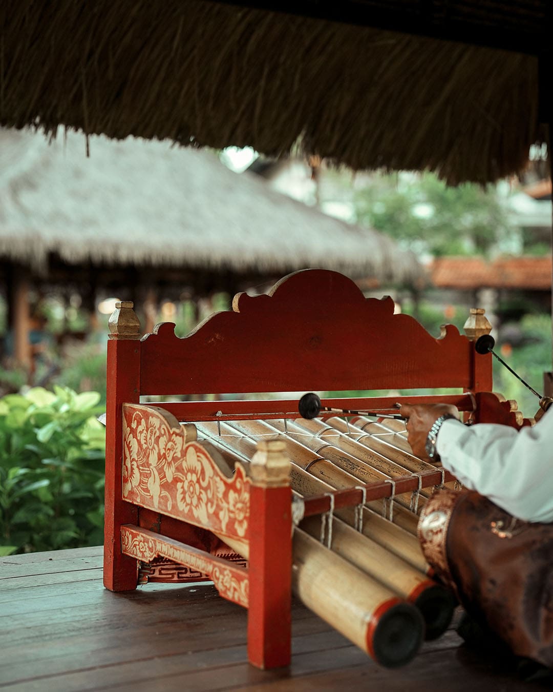 A close-up of a person playing a Rindik, in Bali