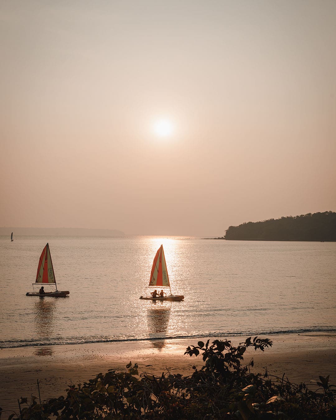 Boats sailing at sunset at Grand Hyatt Goa, India