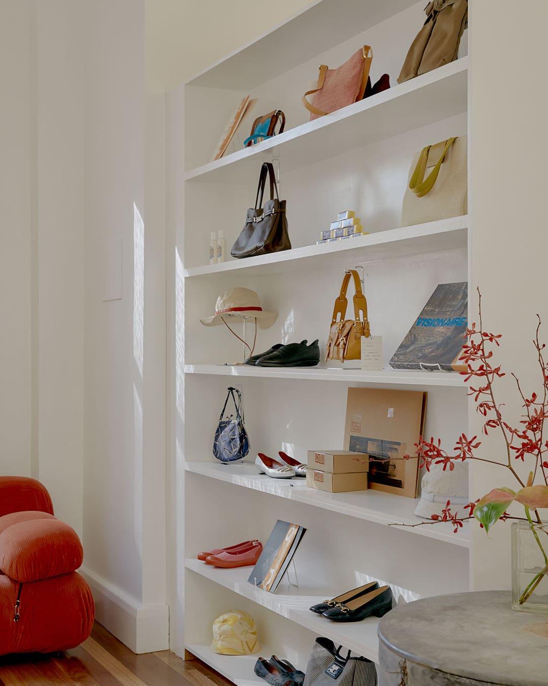 Shoes and accessories beautifully curated on a white shelf at Reina in Melbourne