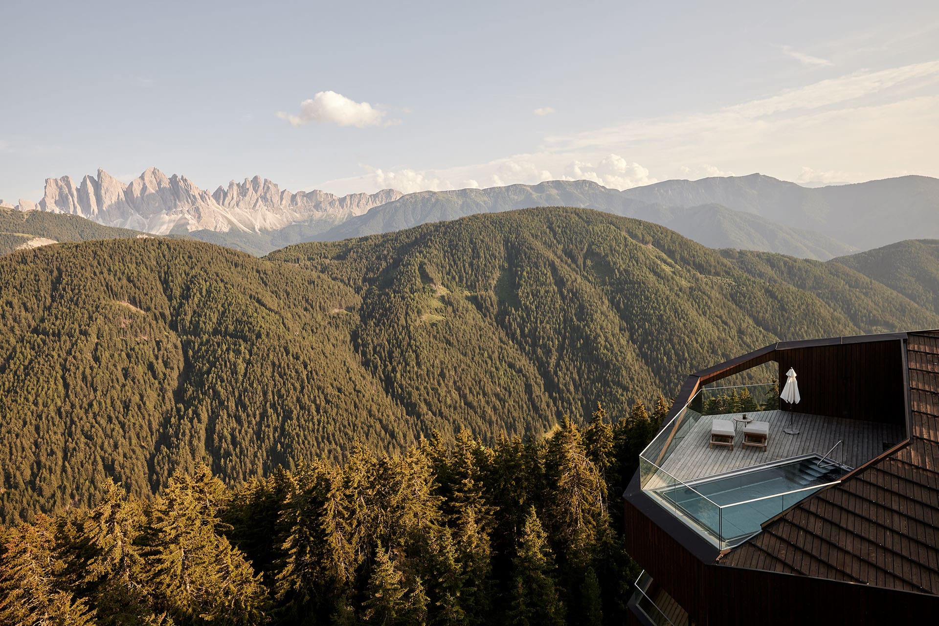 Forestis Dolomites overlooking Geisler peaks and glowing larch trees in autumn