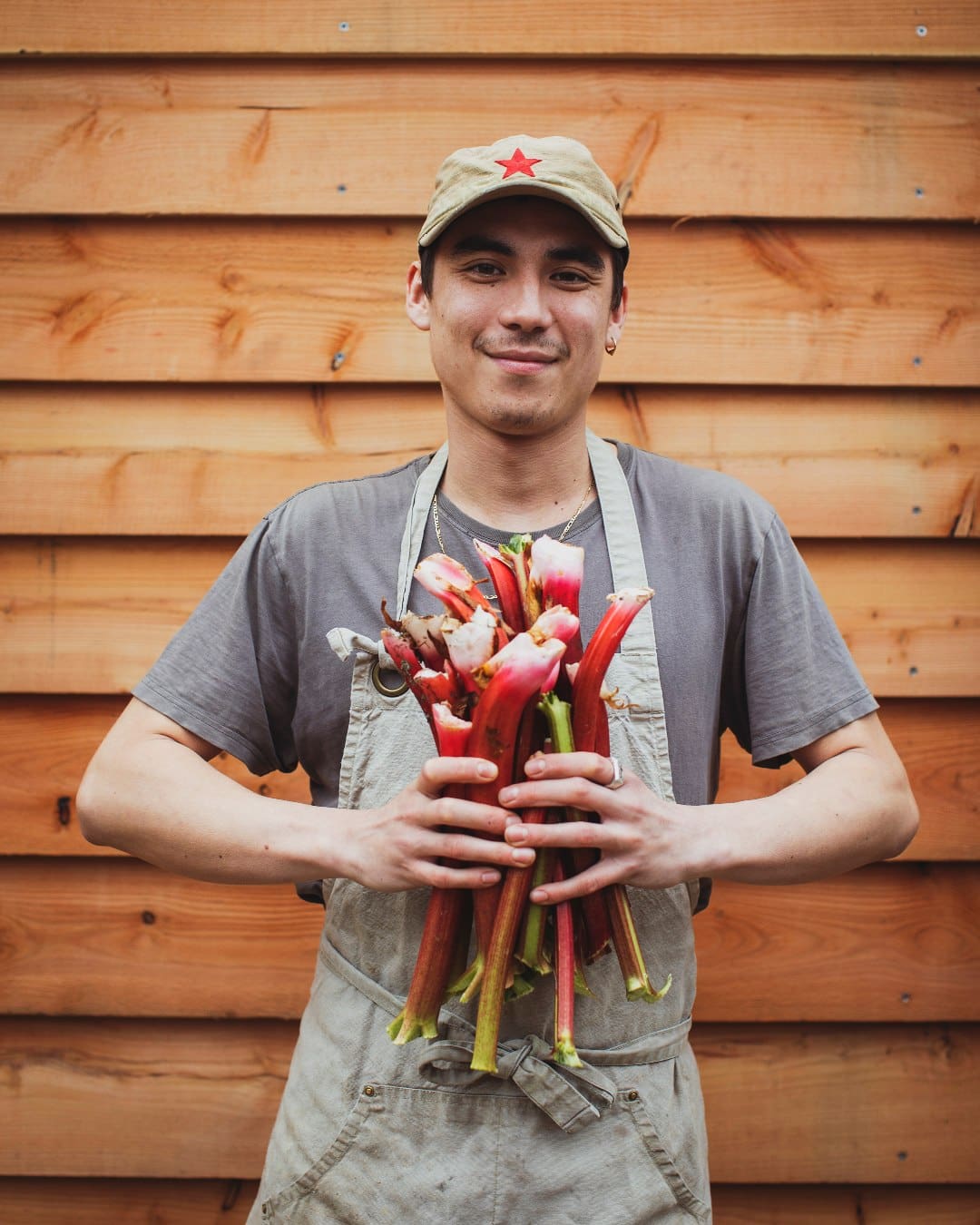 A man holding rhubarb at fforest in Wales