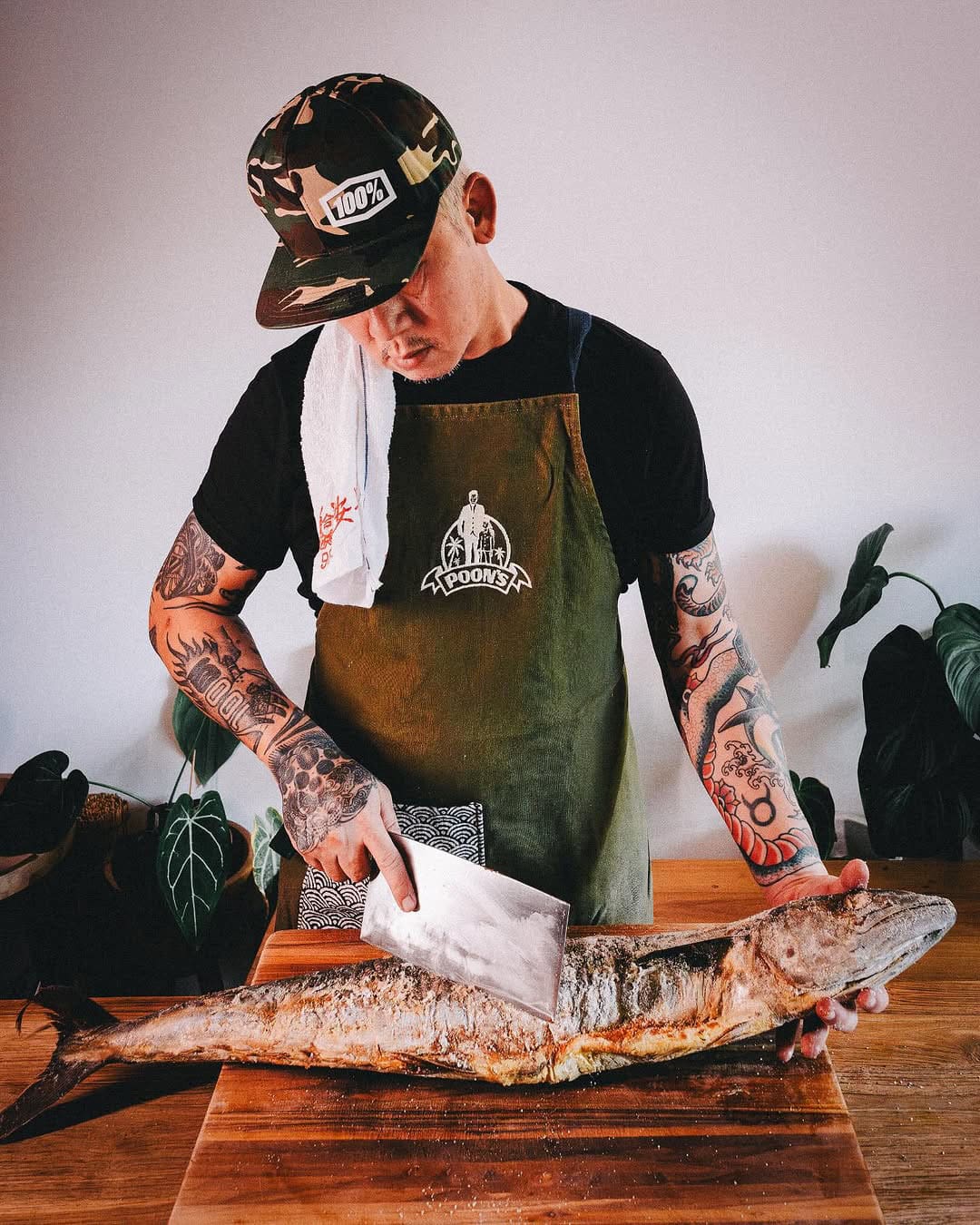 Kevin WY Lee of Poon's Supper Club prepares a fish for one of his recipes