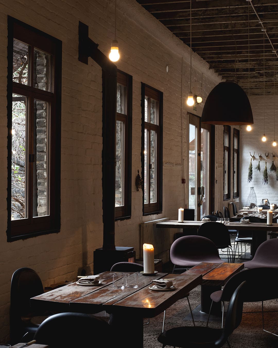 Interior of a modern restaurant, wooden tables and candles