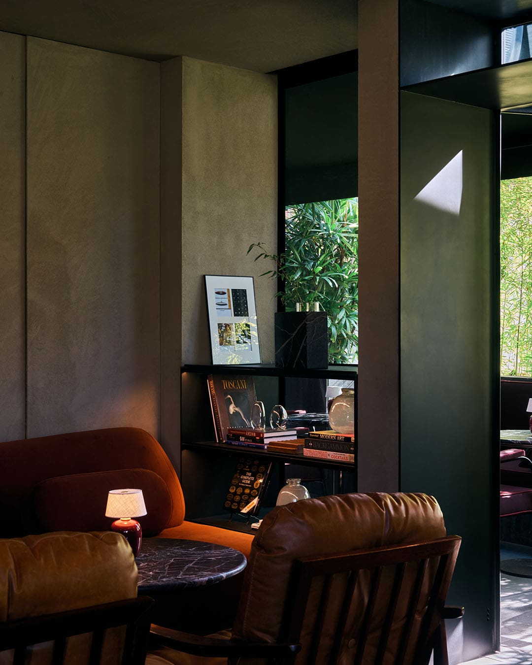 Warming interior and seating of a cigar bar in Beirut. Art books in background